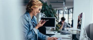 Businesswoman talking on smartphone and looking at documents